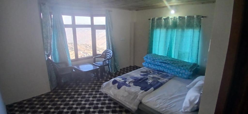 a small bedroom with a bed and a window at Snow Bound Home stay in Fagu