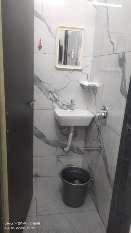 a bathroom with a sink and a toilet at Rr suites in Kākināda