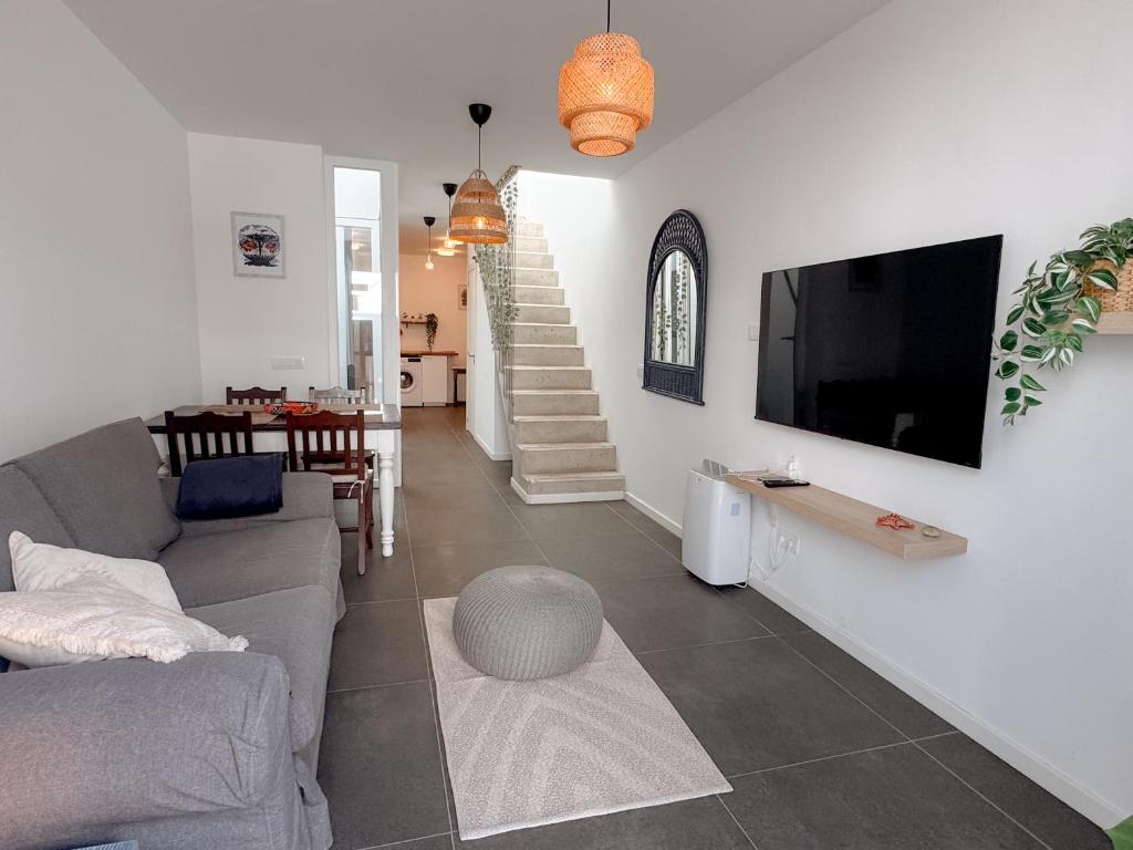 a living room with a couch and a tv at apartment in La Santa, Lanzarote, village by the Sea in La Santa