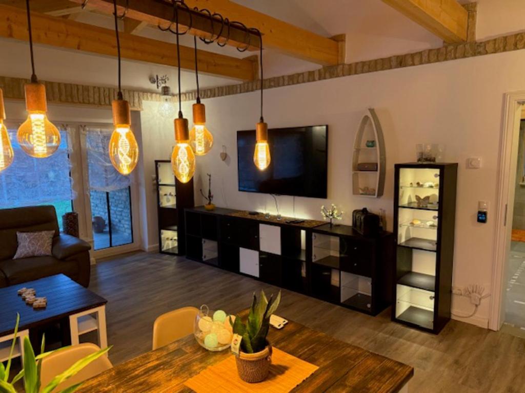a living room with a couch and a television at Villa Toscana in Teltow