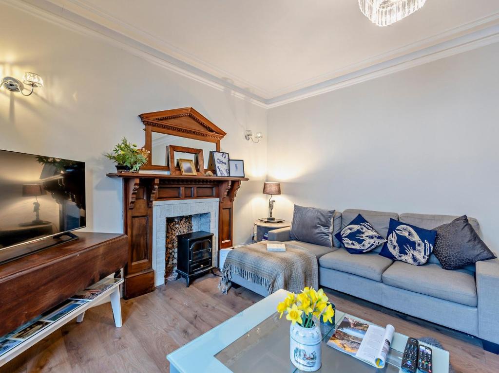 a living room with a couch and a fireplace at Pembroke Lake House in Pembroke
