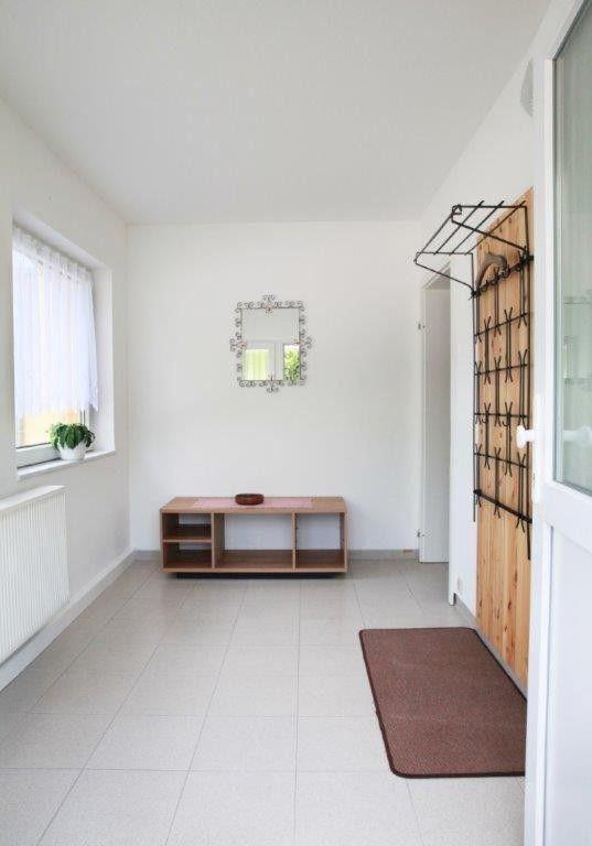 a large white room with a table and a window at Ferienwohnung-Hoffmann-Harzgerode in Harzgerode