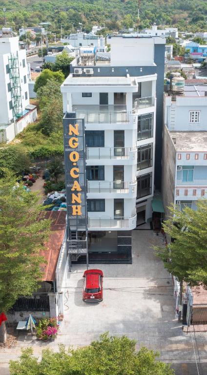 a red car parked in front of a white building at Khách sạn Ngọc Anh in Long Hai