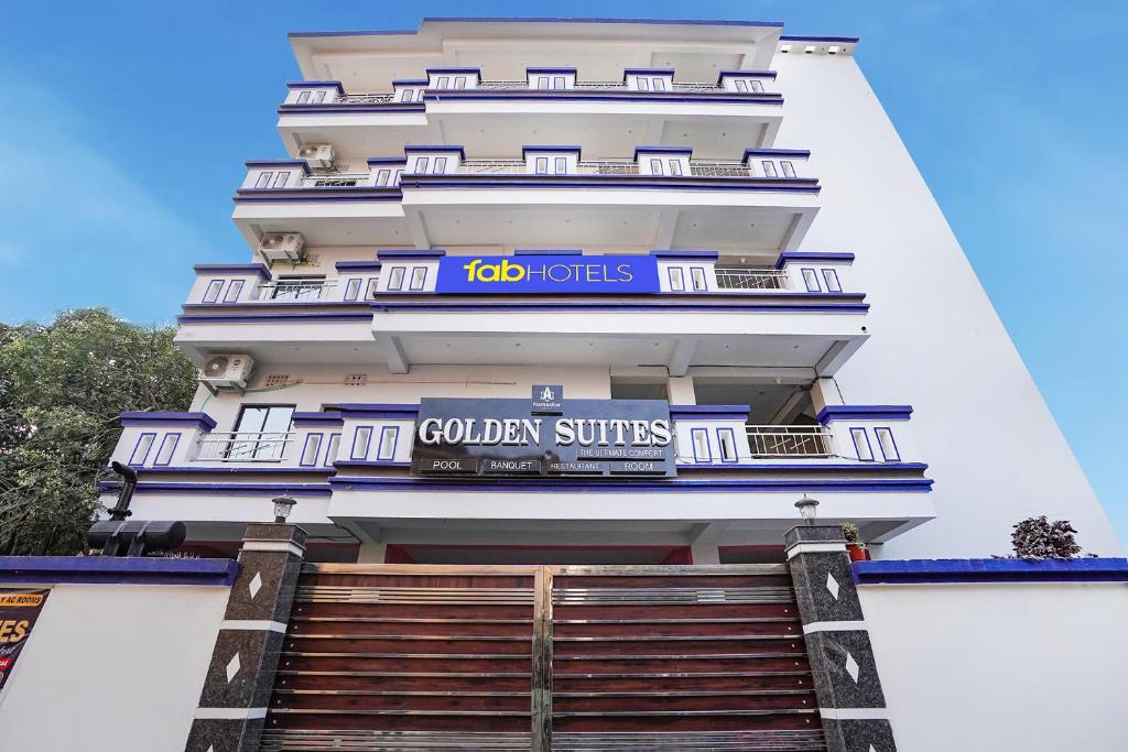 a building with the colombian suites sign on it at FabHotel Golden Suites Near Puri Beach in Puri