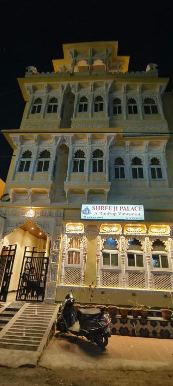 a building with a scooter parked in front of it at Shree ji palace hotel in Udaipur