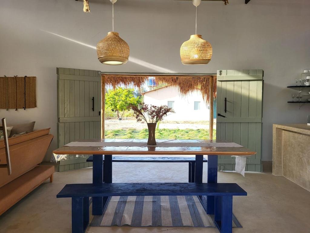 a table with a vase on it in a kitchen at Casa Vento e Mar in Japaratinga