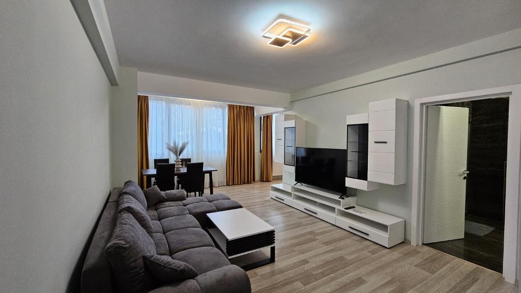 a living room with a couch and a flat screen tv at NORDIC Residence Apart Hotel in Suceava