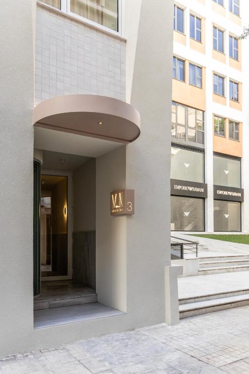 a building with a sign on the side of it at Milioni by Oniro in Athens