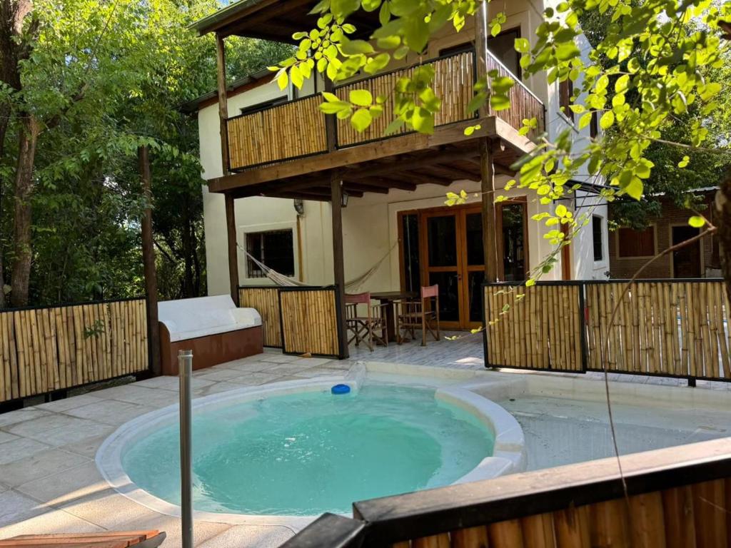 a swimming pool in front of a house at Paraíso Serrano in Casa Grande