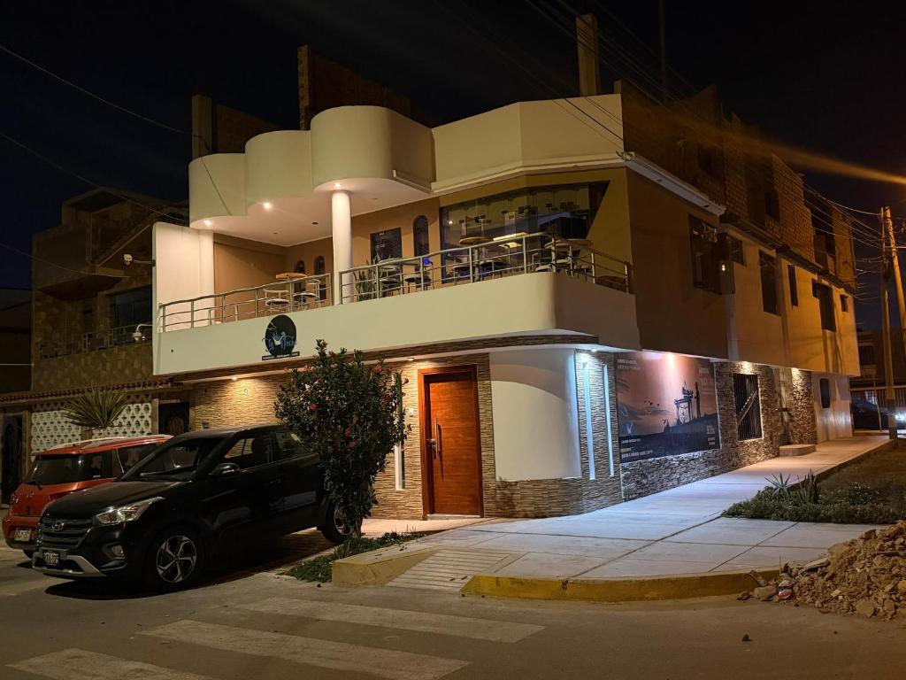 a building with a car parked in front of it at "HOSTAL LA NOCHE" -Pisco in Pisco