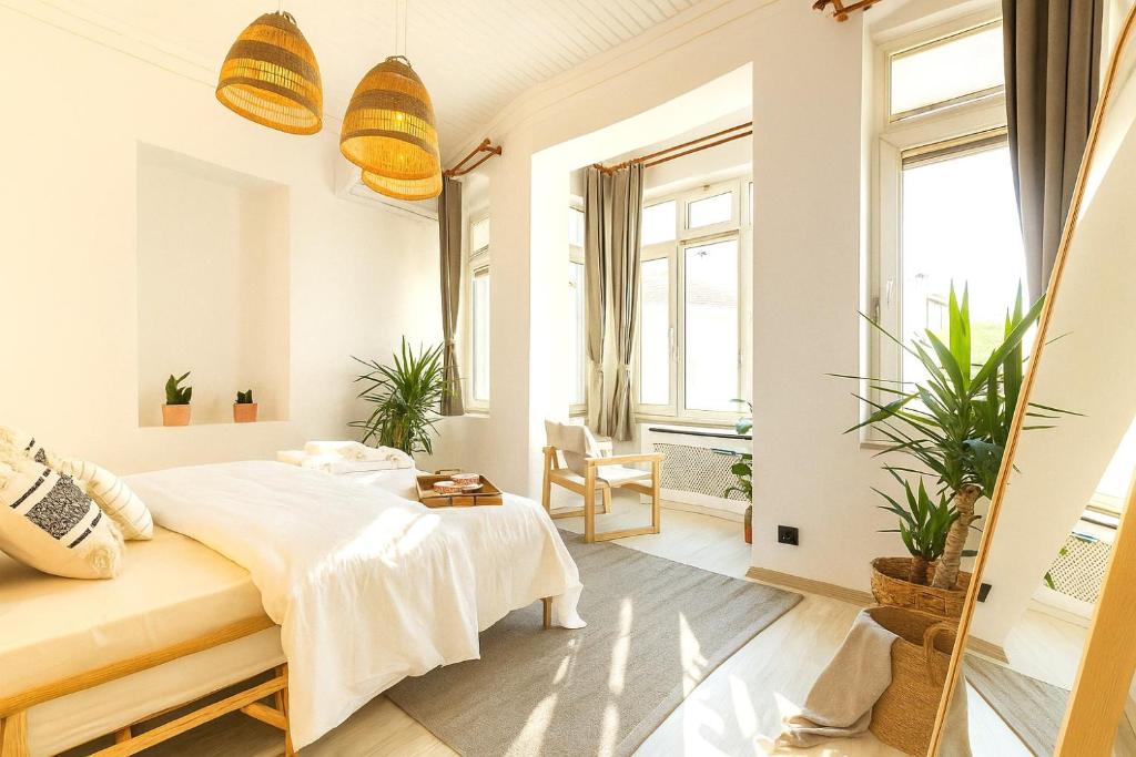a bedroom with a bed and two windows at Maison Istanbulite in Istanbul