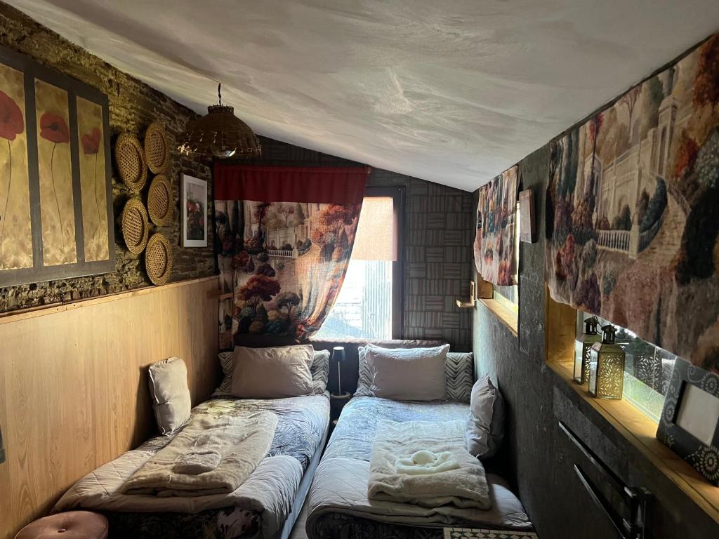 a small room with two beds in it at My cosy space in Spa