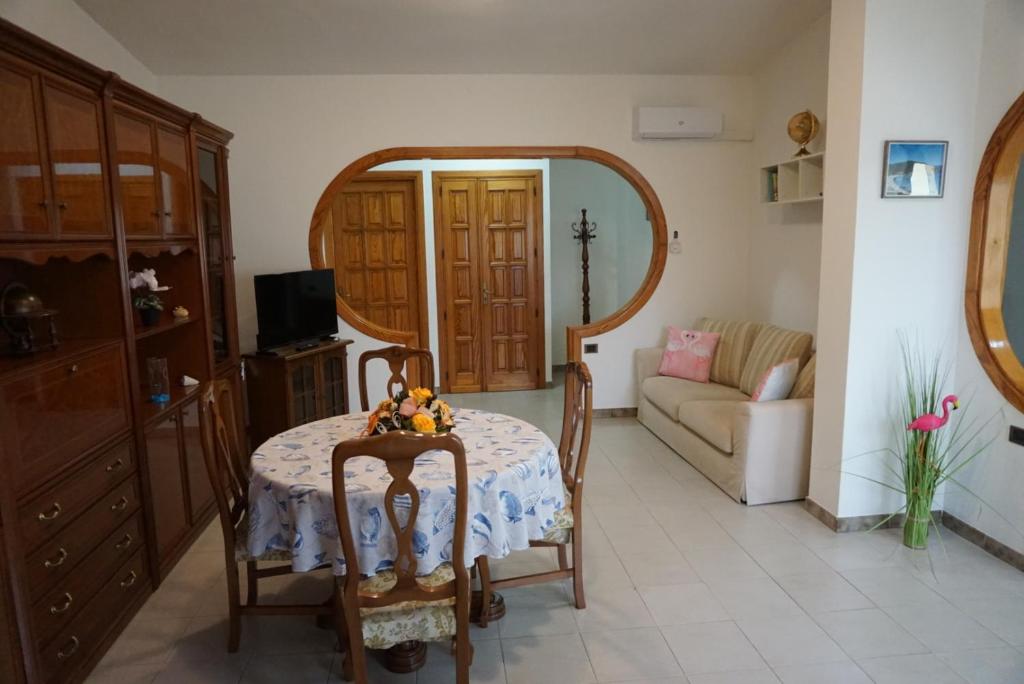 a living room with a table and a couch at Molentargius Domus in Quartu SantʼElena