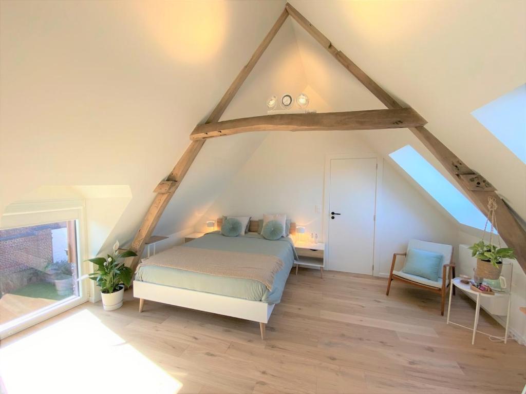 a bedroom with a bed in an attic at The BEE Garden in Lede