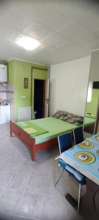 a bedroom with a bed and a table and chairs at Apartman Tomas in Herceg-Novi