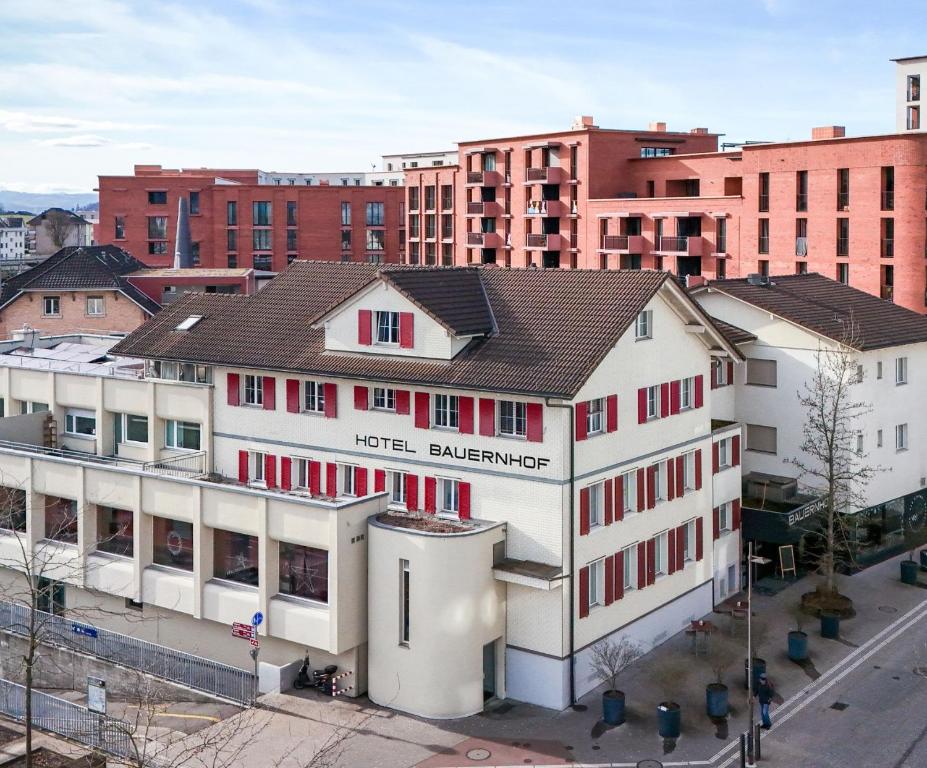 an aerial view of a building in a city at Hotel Bauernhof - Self Check-In Hotel in Rotkreuz