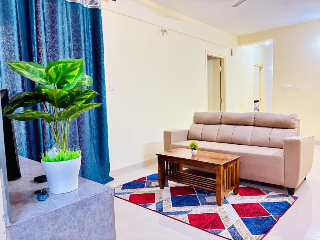 a living room with a couch and a coffee table at AeroNest Homes - 1BHK & 2BHK Quiet & Comfortable Near Airport 7km in Muthugadahalli