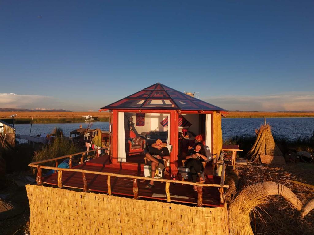 a small house on a boat on the water at TiticacaIntiLodge in Puno