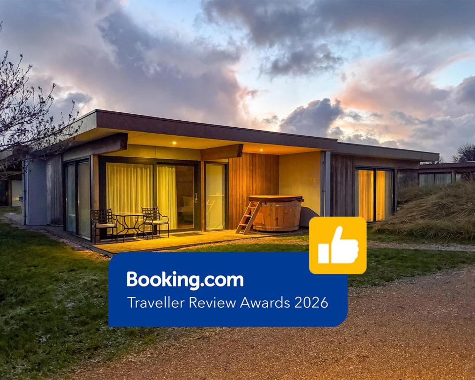 a small house is shown with a sunset at Garden Suites with Private Hottub - Duinhotel in Burgh-Haamstede zeeland in Burgh Haamstede