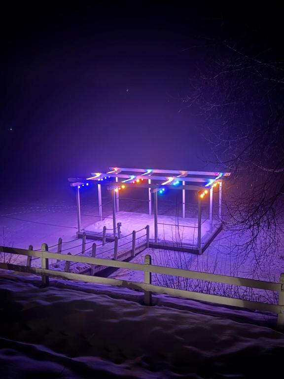 a bus stop in the snow at night at La Măgaru Tăvălit in Nucşoara