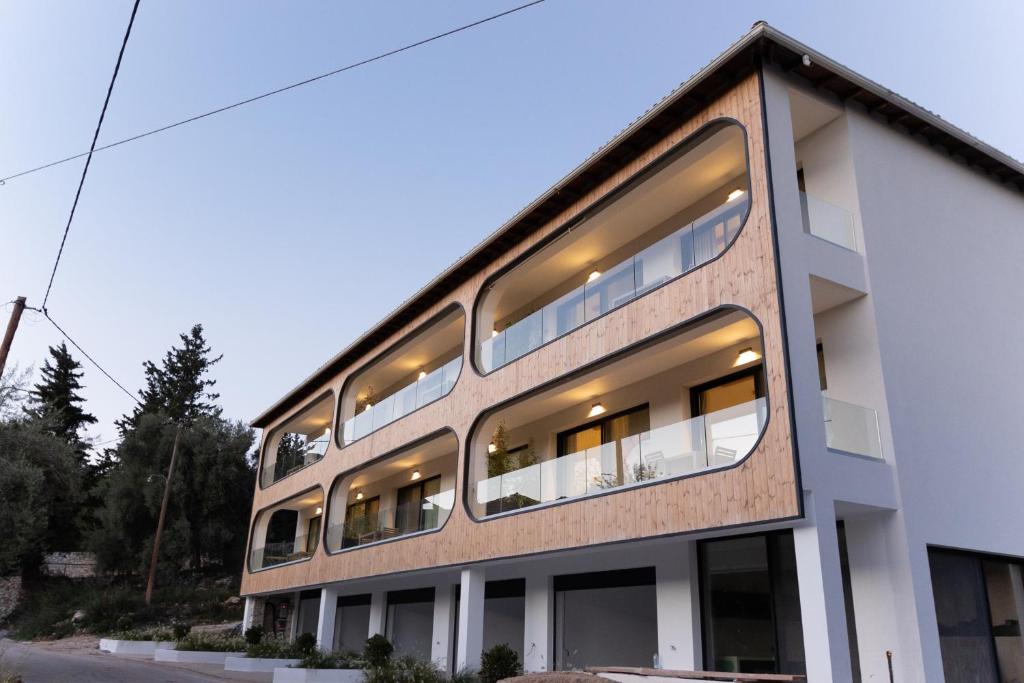 an external view of a building with many windows at Aella Exclusive Residences Lefkada in Mikros Gialos