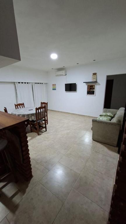a living room with a table and a couch at Chacra Arcoiris in Gualeguay