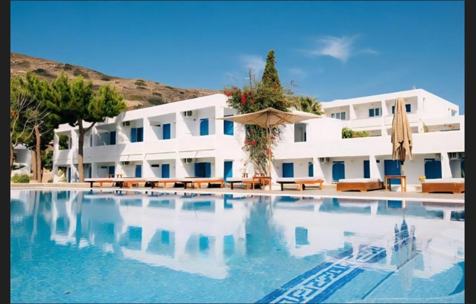 a large swimming pool in front of a building at Lagada Beach Hotel in Adamantas