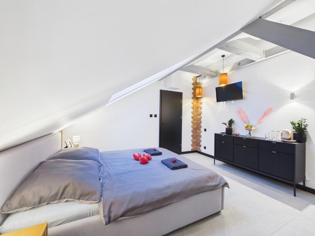 a bedroom with a bed with red pillows on it at Romantic Studio Marki LoveAparts in Marki