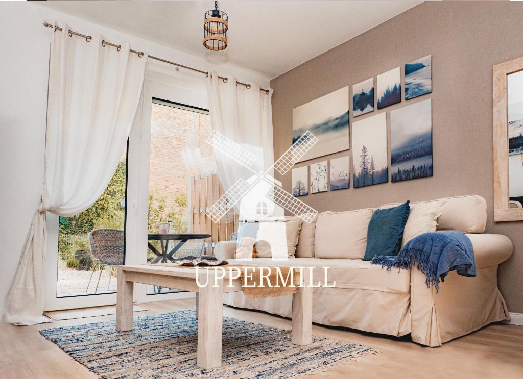 a living room with a couch and a table at Uppermill Suite #3 in Pécs