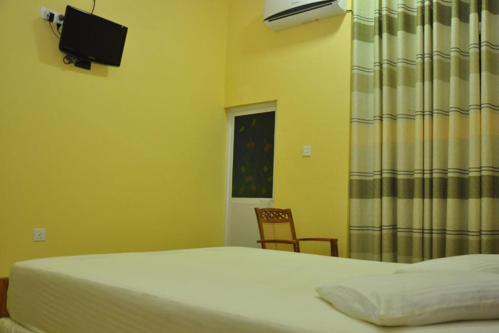 Postel nebo postele na pokoji v ubytování Hotel Pearl Gate