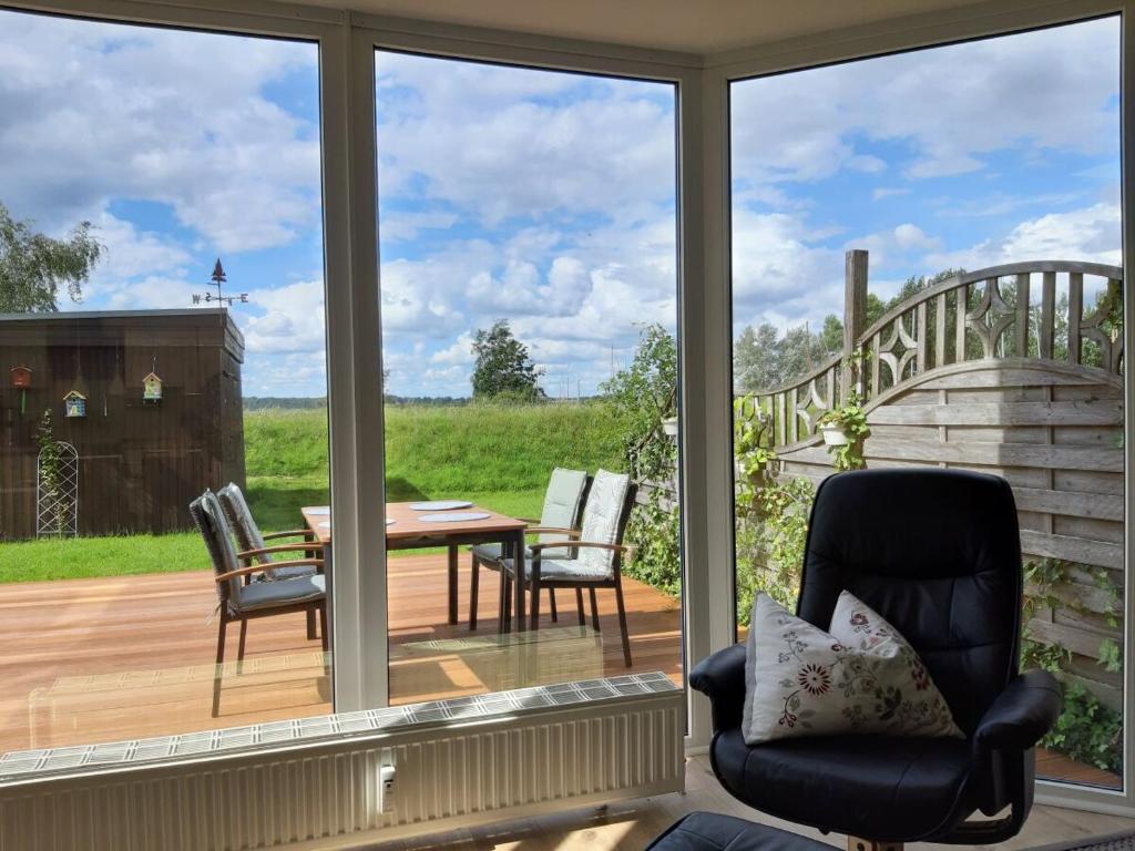 a screened in porch with a table and chairs at Ferienwohnung Strickert in Stexwig in Stexwig