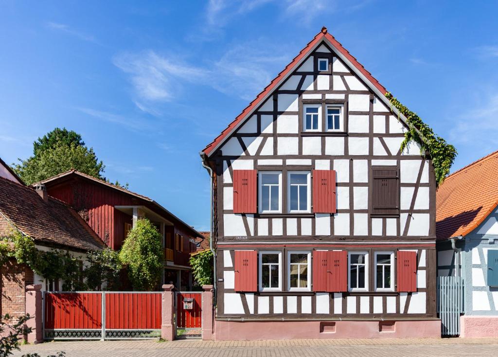 a black and white house with red shutters at Olive Garden in Groß-Bieberau