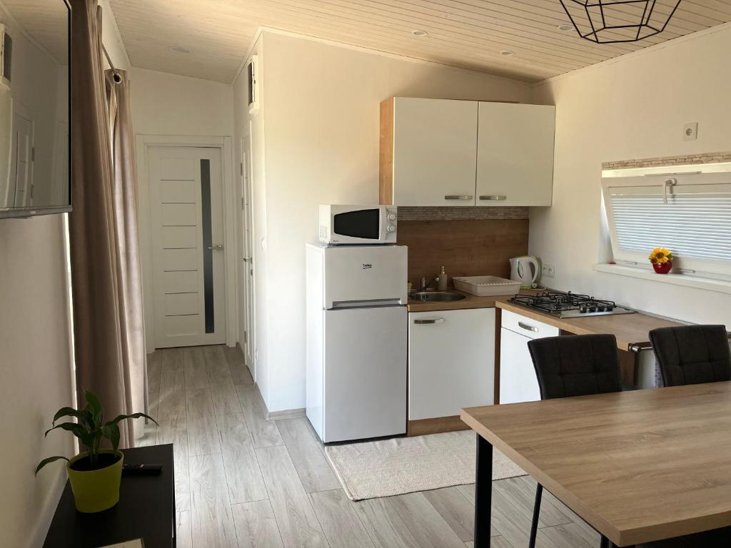 a kitchen with a white refrigerator and a table at Domček in Budimír