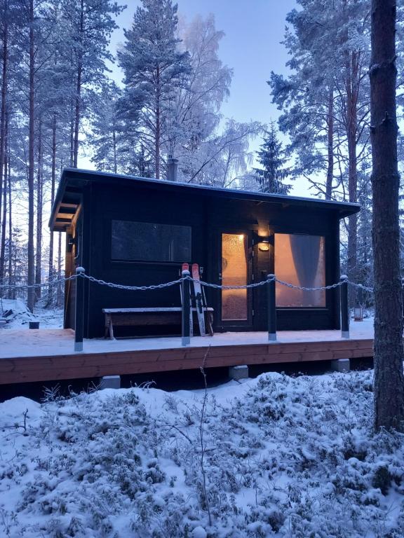 a cabin in the woods in the snow at Nature resort Linnunrata in Oulu