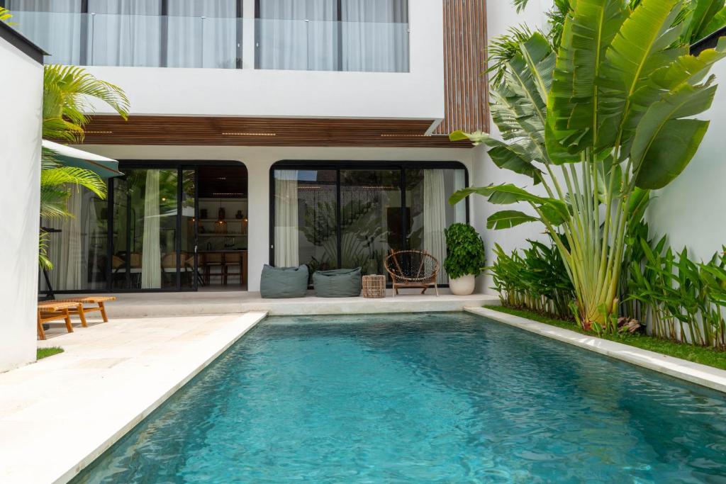 a swimming pool in the backyard of a house at Unity Villa 1 Canggu in Canggu