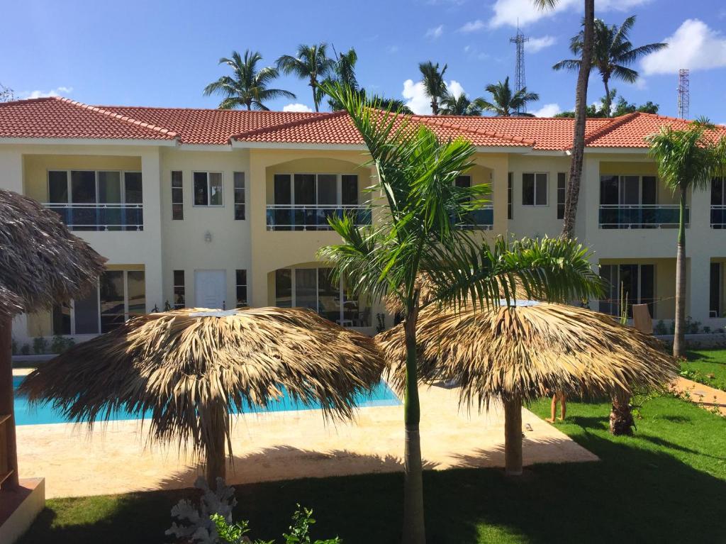 a resort with palm trees and a swimming pool at Las Galeras Hotel in Las Galeras