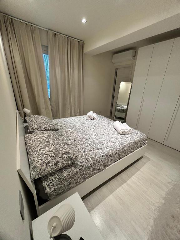 a bedroom with a bed and a large window at CARPI SUITE - Appartamenti Minghetti in Carpi
