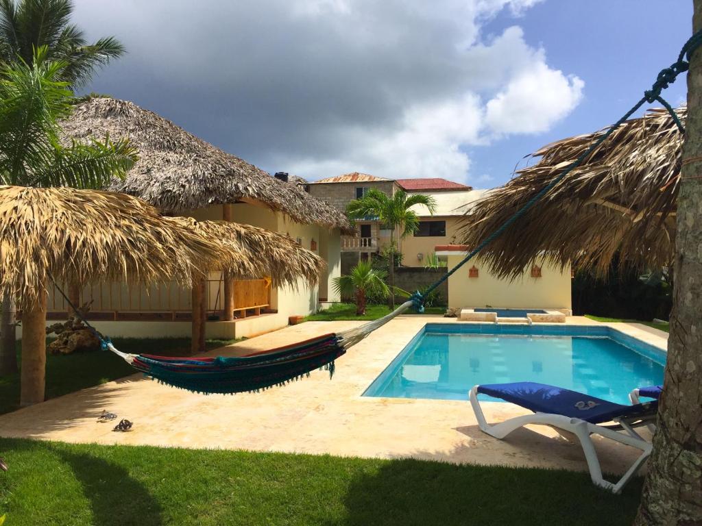 a resort with a hammock and a swimming pool at Las Galeras Hotel in Las Galeras