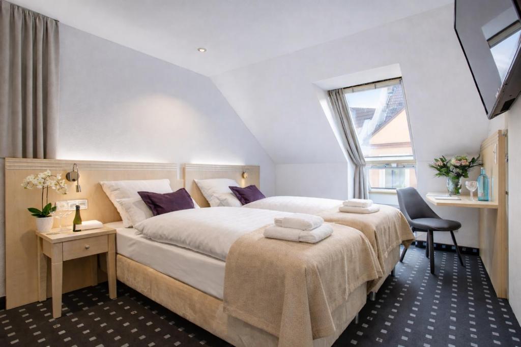 a bedroom with a large bed and a window at Rhein Neckar Hotel Mannheim 24h Self Check-in in Mannheim