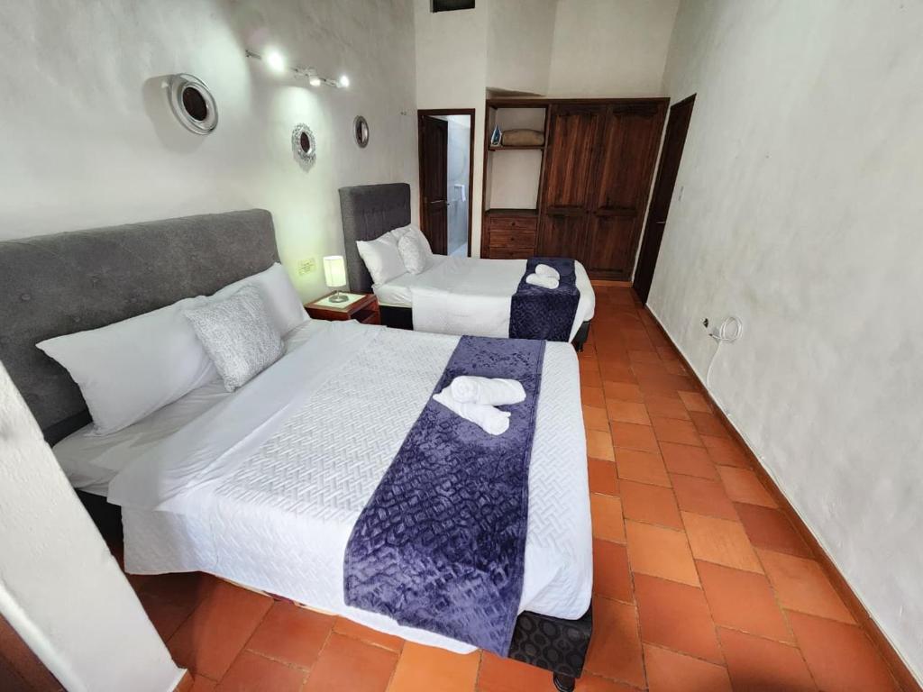 a hotel room with two beds in a room at Apartamento de la Villa I in Villa de Leyva