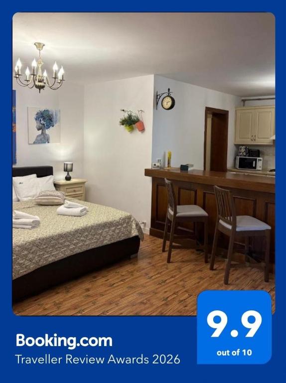 a bedroom with a bed and a desk and a kitchen at Marsali Studio in Constanţa