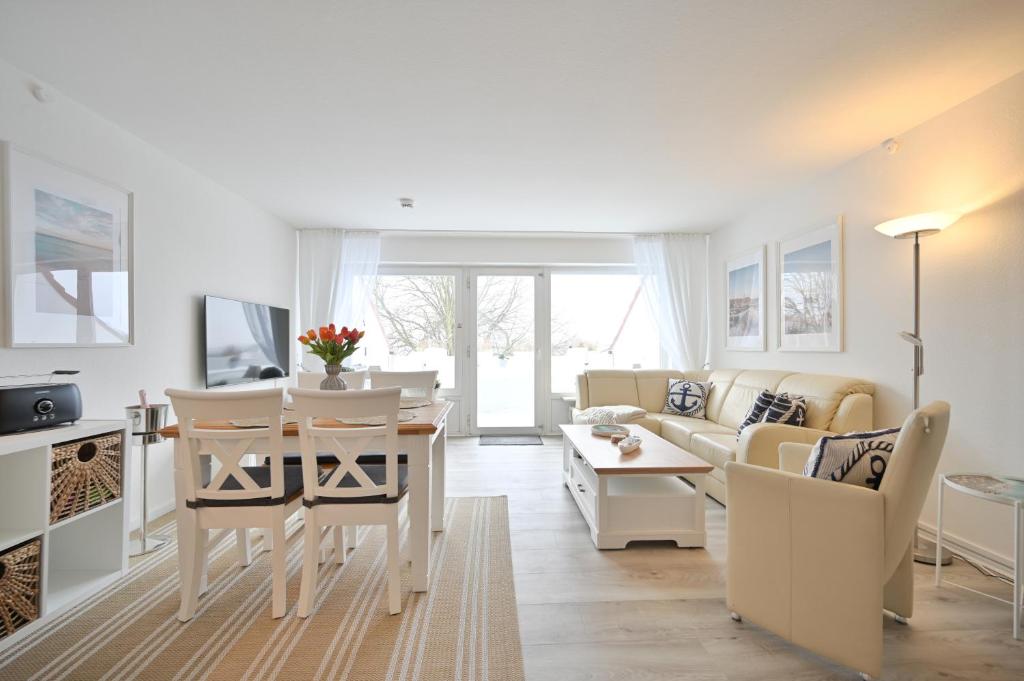 a living room with a table and a dining room at Küstenkinder Whg 17 in Kellenhusen