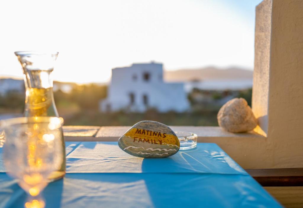 a table with a bottle and a ball on it at Matina's Family in Mikri Vigla