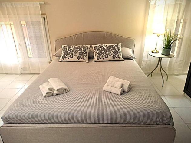 a bedroom with a bed with towels on it at Residence Borghesi in Parma