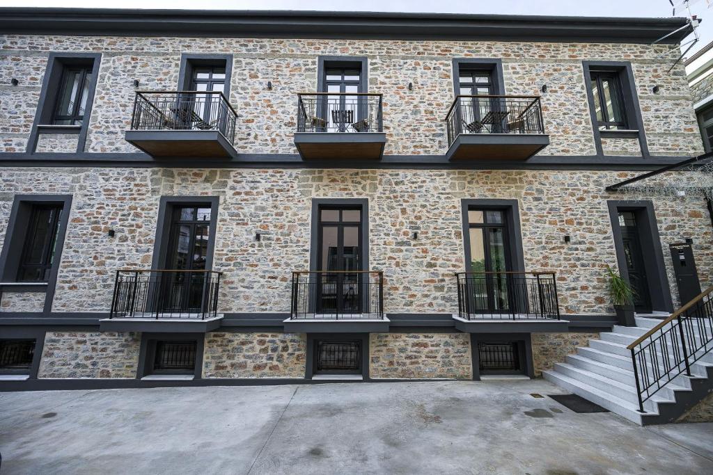 a building with balconies on the side of it at Lithos Boutique Residences in Volos
