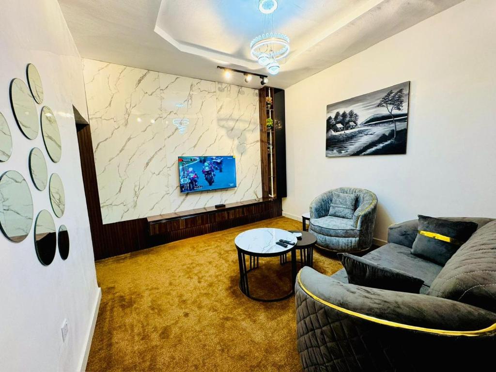 a living room with a couch and a table at Premium Luxury Apartments in Abuja