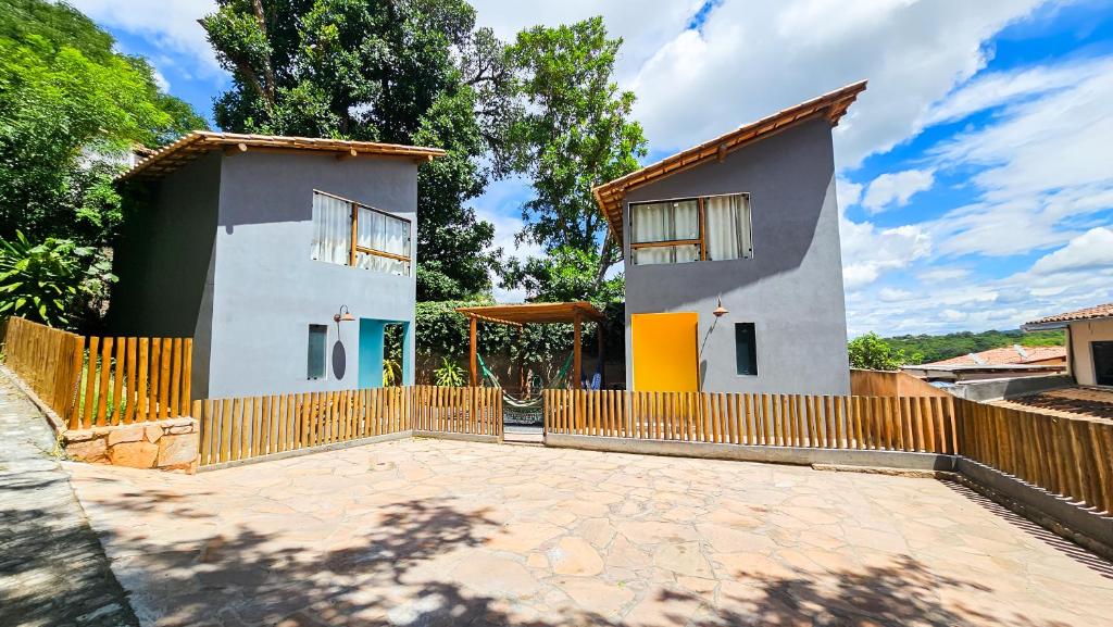 a house with a fence in front of it at Saíra Chalés in Lençóis