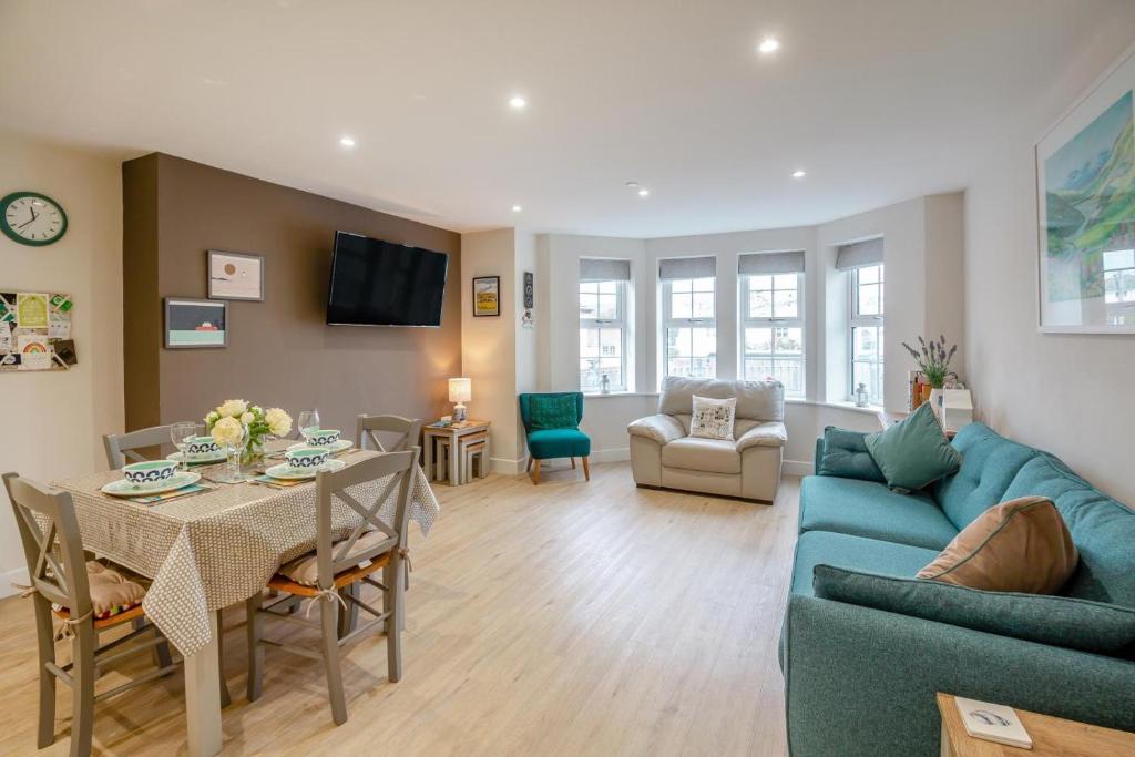 a living room with a blue couch and a table at 2 Bed in Benllech oc-t34071 in Benllech
