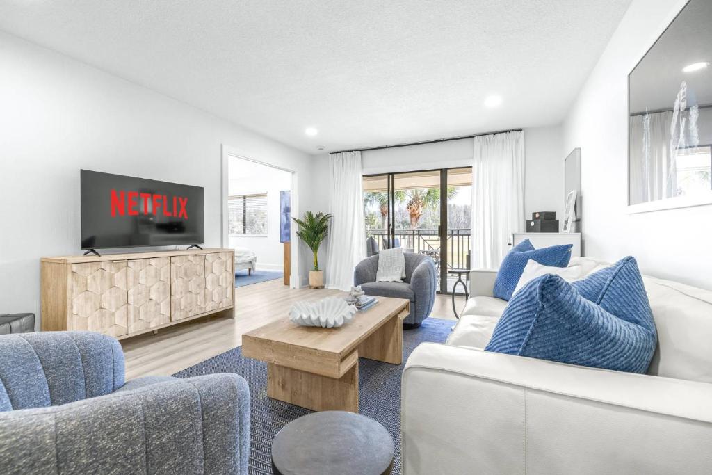a living room with a couch and chairs and a tv at Golf Coast Bleu III - 3158-3160 in Zephyrhills