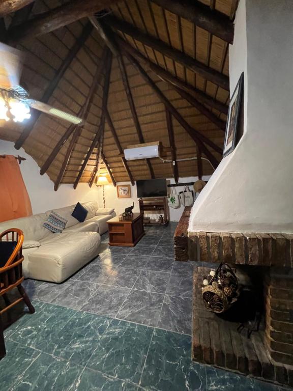 a living room with a couch and a fireplace at Apartamento en planta alta 2 dormitorios in Piriápolis